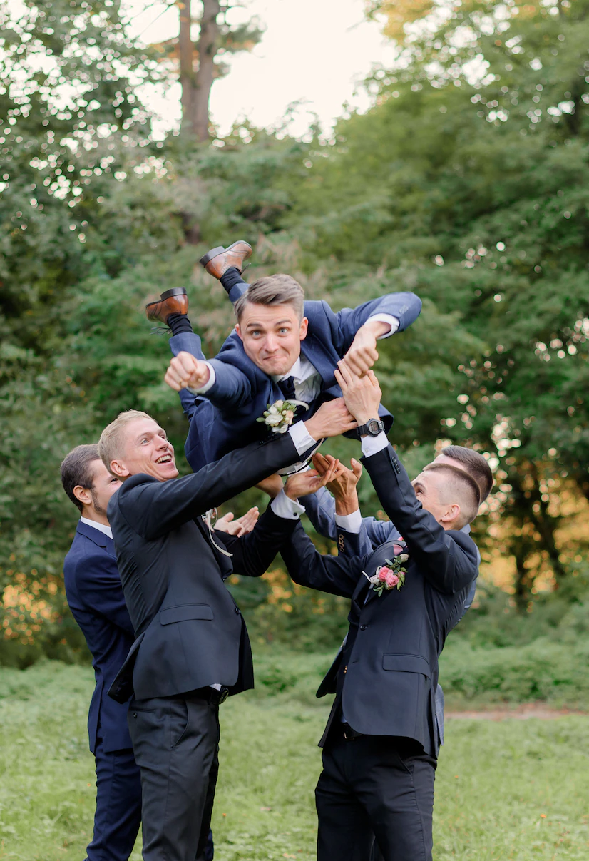 best-men-are-throwing-up-groom-outdoors-in-the-park-funny-wedding-day_8353-11235-2